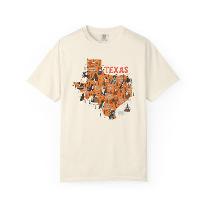 Beige t-shirt with an orange map of Texas featuring various dogs and state icons